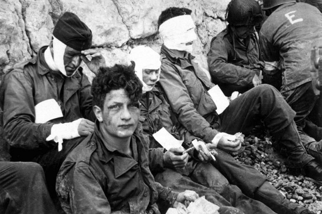 american troops of the 16th infantry regiment injured while storming omaha beach waiting to be evacuated to a field hospital in normandy france on june 6 1944 photo u s army american troops of the 16th infantry regiment injured while storming omaha beach waiting to be evacuated to a field hospital in normandy france on june 6 1944 photo u s army