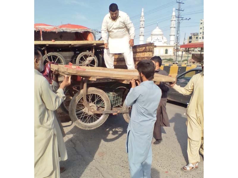 cda workers haul away pushcarts during anti encroachment drive photo express