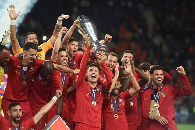 portugal 039 s forward cristiano ronaldo raises the trophy as he celebrates with teammates winning the uefa nations league final football match between portugal and the netherlands at the dragao stadium in porto photo afp