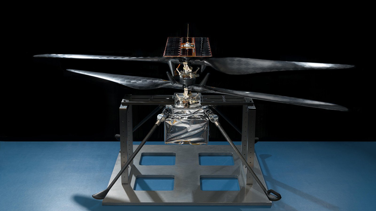 this image of the flight model of nasa 039 s mars helicopter was taken on feb 14 2019 in a cleanroom at nasa 039 s jet propulsion laboratory in pasadena california the aluminum base plate side posts and crossbeam around the helicopter protect the helicopter 039 s landing legs and the attachment points that will hold it to the belly of the mars 2020 rover image credit nasa jpl caltech