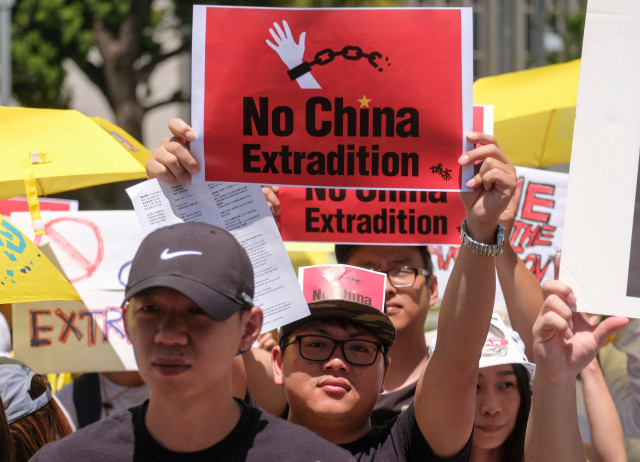 protesters march during a demonstration to protest against a controversial extradition law proposed by hong kong 039 s pro beijing government to ease extraditions to china in los angeles on june 9 2019 protesters march during a demonstration to protest against a controversial extradition law proposed by hong kong 039 s pro beijing government to ease extraditions to china in los angeles on june 9 2019