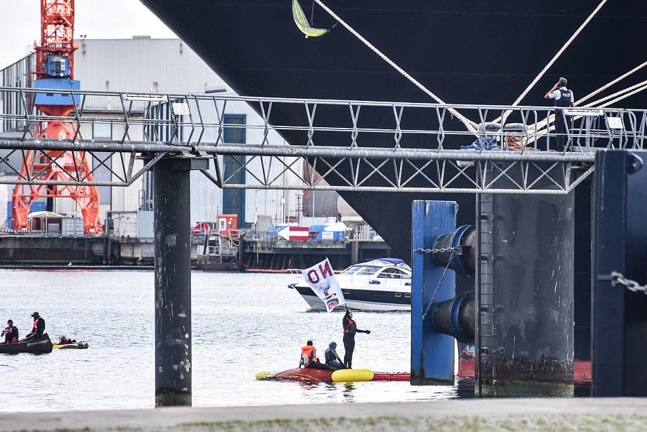 a picture taken on june 9 2019 shows climate activists of the quot smash cruiseshit quot group on a small boat during an operation to block the zuiderdam cruise ship at kiel 039 s harbour to protest against its carbon emissions courtesy afp