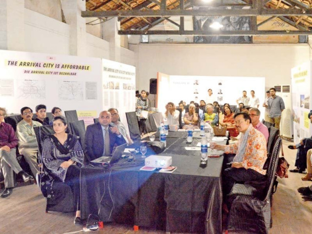 attendees watch a presentation at the arrival city exhibit photos courtesy of goethe institut pakistan attendees watch a presentation at the arrival city exhibit photos courtesy of goethe institut pakistan