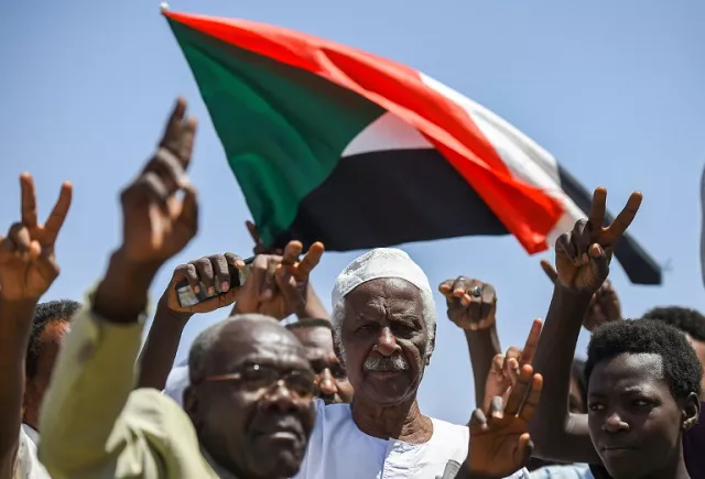 sudanese protesters chant slogans flash v for victory signs and wave the national flag at the sit in outside the army headquarters in the capital khartoum on may 14 2019 photo afp sudanese protesters chant slogans flash v for victory signs and wave the national flag at the sit in outside the army headquarters in the capital khartoum on may 14 2019 photo afp