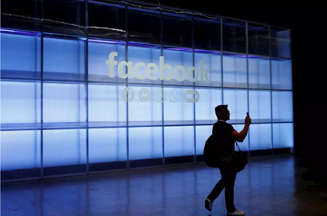 an attendee takes a photograph of a sign during facebook inc 039 s f8 developers conference in san jose california us april 30 2019 photo reuters