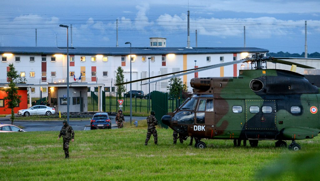 french soldiers stand next to a chopper in front of the penitentiary center of alen on in conde sur sarthe northwestern france during a hostage taking on june 11 2019 photo afp