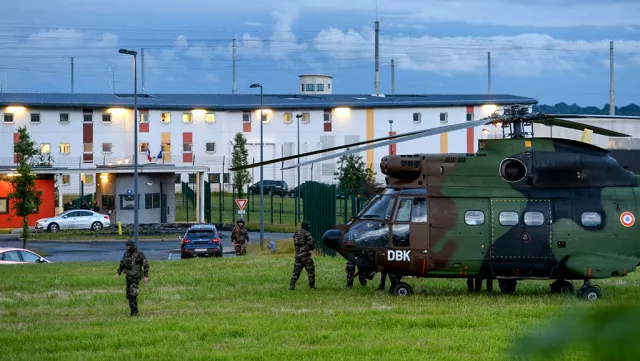 french soldiers stand next to a chopper in front of the penitentiary center of alen on in conde sur sarthe northwestern france during a hostage taking on june 11 2019 photo afp french soldiers stand next to a chopper in front of the penitentiary center of alen on in conde sur sarthe northwestern france during a hostage taking on june 11 2019 photo afp
