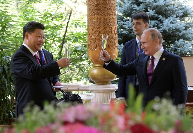 russian president vladimir putin r toasts with chinese president xi jinping while congratulating him on his birthday photo reuters