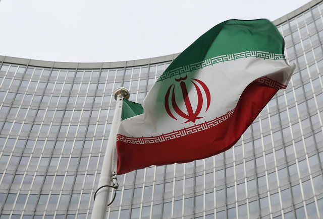 an iranian flag flutters in front of the international atomic energy agency iaea headquarters in vienna austria photo reuters