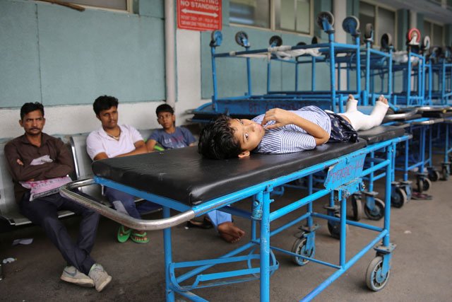 a boy lies on a stretcher waiting for treatment photo reuters