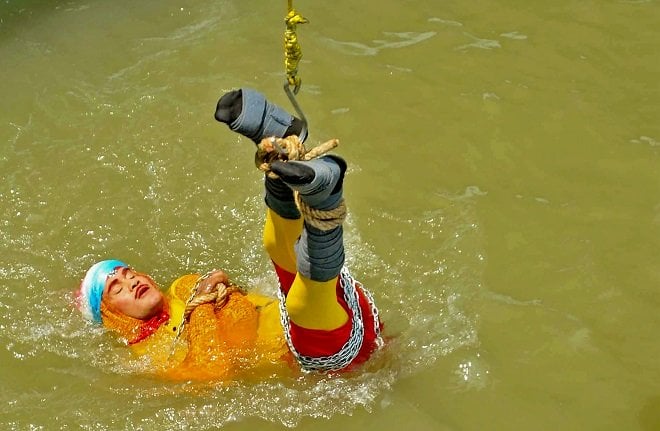 photo of indian stuntman chanchal lahiri known by his stage name quot jadugar mandrake quot while preparing for being lowered into the ganges river photo afp