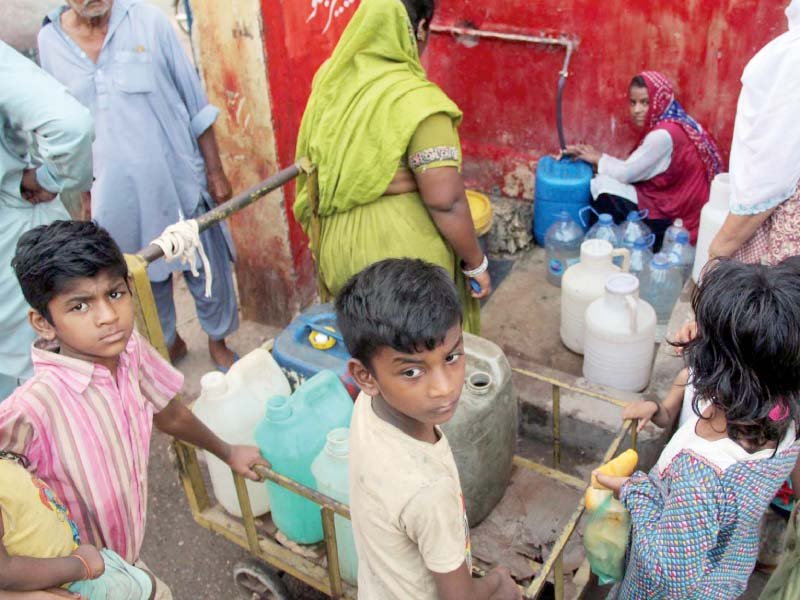 women and children gather to collect water from a public tap in bheempura water scarcity in the provincial capital remains a regular nuisance for the citizens of karachi photo online