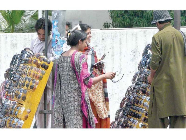 passers by selecting sunglasses from roadside vendors photo app passers by selecting sunglasses from roadside vendors photo app