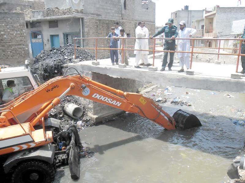 an excavator dredges a storm drain in rawalpindi photo agha mehroz express