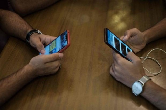 young people using their phones to access the internet at a cafe following a nation wide mobile internet blackout in the sudanese capital khartoum photo afp young people using their phones to access the internet at a cafe following a nation wide mobile internet blackout in the sudanese capital khartoum photo afp