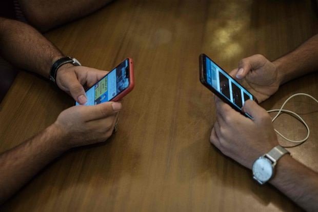 young people using their phones to access the internet at a cafe following a nation wide mobile internet blackout in the sudanese capital khartoum photo afp