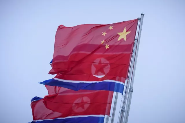 north korean and chinese flags fly on kim il sung square in pyongyang photo afp north korean and chinese flags fly on kim il sung square in pyongyang photo afp