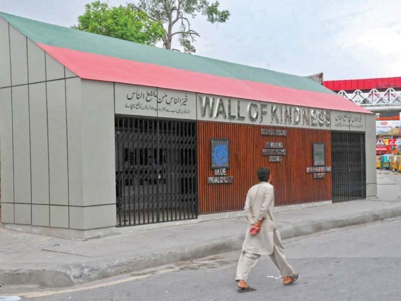 a man walks past the closed wall of kindness set up by the rawalpindi development authority photo agha mehroz express