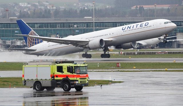 a vehicle of the airport rescue and firefighting services stands in front as a boeing 767 400er aircraft of united airlines takes off from zurich airport april 9 2019 photo reuters