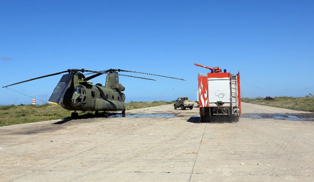 in this file photo a firefighting truck is parked next to an italian built libyan chinook ch 47 military helicopter that was hit by shrapnel following an air strike at mitiga international airport in early april photo afp in this file photo a firefighting truck is parked next to an italian built libyan chinook ch 47 military helicopter that was hit by shrapnel following an air strike at mitiga international airport in early april photo afp