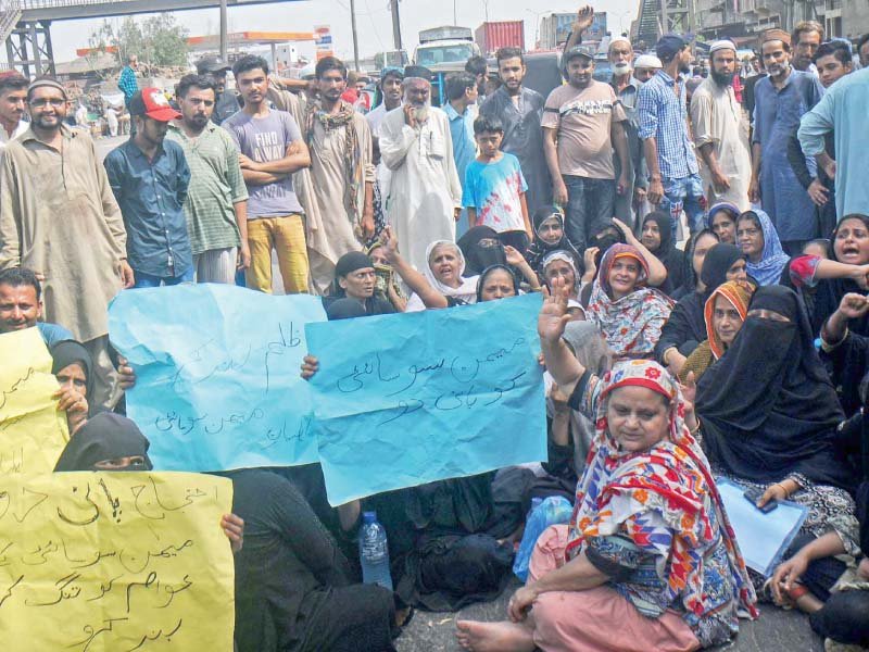 residents including women and children resort to protest early monday morning against the prolonged water suspension the protesters erecting barriers blocked mauripur road and shouted slogans against the kwsb photo ppi