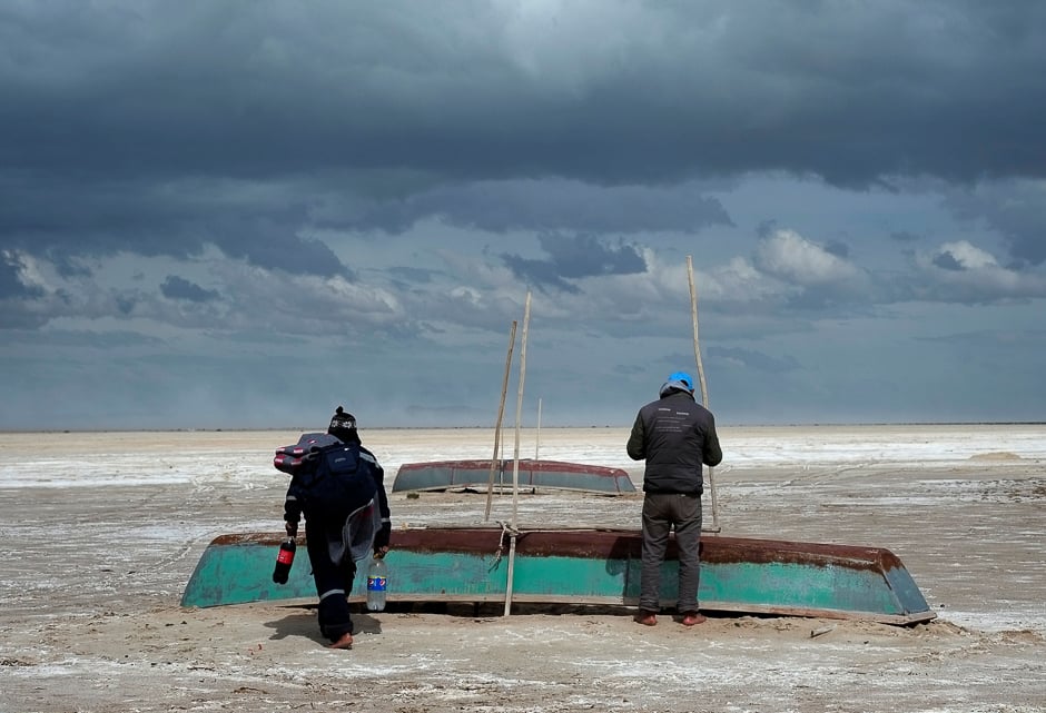 Fishermen and their boats are seen, where a slight water recovery is observed at Poopo Lake, Oruro, Bolivia. PHOTO: REUTERS