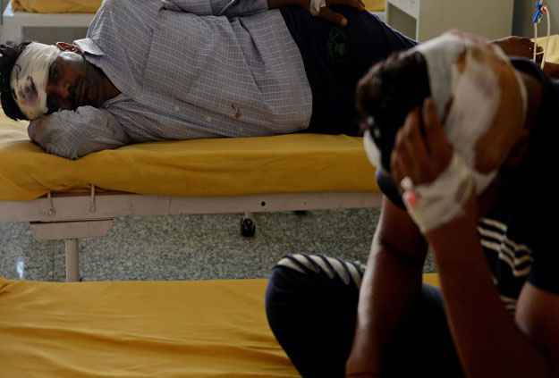 Injured followers of religious leader Gurmeet Ram Rahim Singh recuperate after receiving treatment at the civil hospital in Panchkula on August 26, 2017. PHOTO: AFP 