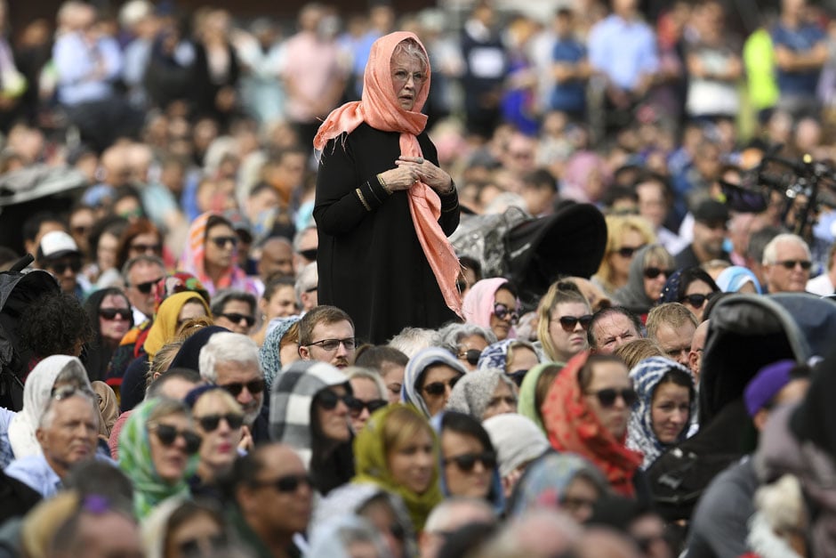 Members of the public look on during a gathering for congregational Friday prayers and two minutes of silence for victims of the twin mosque massacre, at Hagley Park in Christchurch. PHOTO: AFP