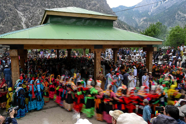 In this picture taken on May 16, 2019, Kalash women wearing traditional dresses dance as they celebrate 'Joshi', a festival to welcome the arrival of spring, at Bumburate village in the mountainous valleys in northern Pakistan. PHOTO: AFP