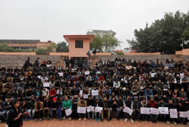 Students of Jamia Millia Islamia university during demonstration after police entered the university campus. PHOTO: REUTERS