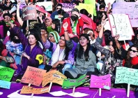 women hold placards at aurat march karachi 2024 photo file