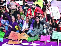 women hold placards at aurat march karachi 2024 photo file