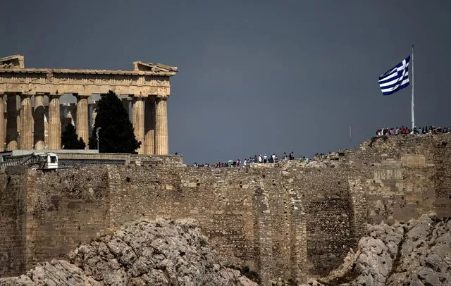 in this file photo greek flag flutters in front of the ancient parthenon temple atop the acropolis hill archaeological site in athens greece photo reuters in this file photo greek flag flutters in front of the ancient parthenon temple atop the acropolis hill archaeological site in athens greece photo reuters