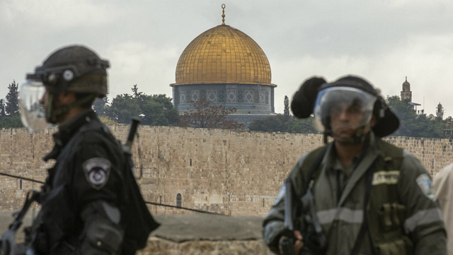 two israeli security personnel stand in front of al aqsa mosque photo afp