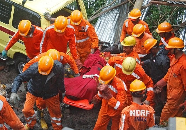 rescue workers carry the body of a victim at the site of a collapsed wall of a residential complex in pune india photo reuters rescue workers carry the body of a victim at the site of a collapsed wall of a residential complex in pune india photo reuters