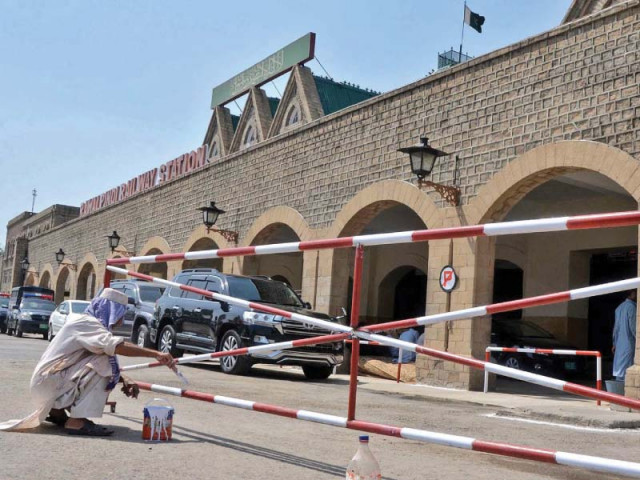 a worker paints a barrier at the rawalpindi railway station ahead of pm s visit photo inp a worker paints a barrier at the rawalpindi railway station ahead of pm s visit photo inp