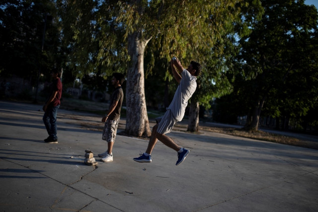 a pakistani man living in greece bawls a ball during a tape ball cricket game in a parking lot in the tavros neighbourhood in athens greece june 29 2019 picture taken june 29 2019 photo reuters a pakistani man living in greece bawls a ball during a tape ball cricket game in a parking lot in the tavros neighbourhood in athens greece june 29 2019 picture taken june 29 2019 photo reuters