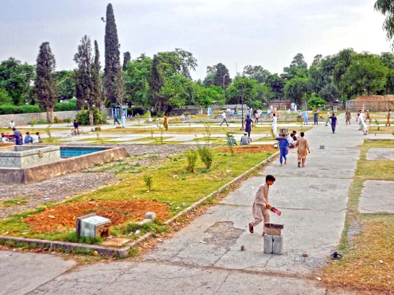 children play in argentina park where ihc has stopped extension of polyclinic photo zafar aslam express