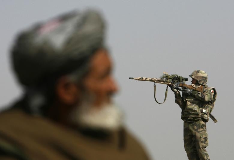 A French sniper looks through his rifle's scope while keeping watch over Qarabagh district, north of Kabul, November 20, 2007. [Photo: Reuters]