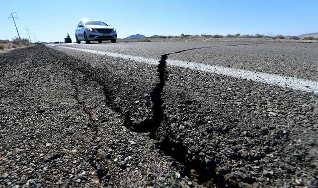cracks are seen on the road after the earthquake photo afp cracks are seen on the road after the earthquake photo afp