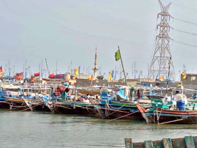 boats stand ashore at a fish harbour along the karachi s 129 kilometre long coastline as fishermen remain restricted from fishing photo express boats stand ashore at a fish harbour along the karachi s 129 kilometre long coastline as fishermen remain restricted from fishing photo express
