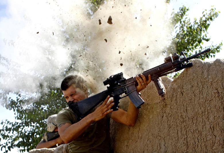 Sgt. William Olas Bee, a US Marine from the 24th Marine Expeditionary Unit, has a close call after Taliban fighters opened fire near Garmsir in Helmand Province of Afghanistan, May 18, 2008. [Photo: Reuters]