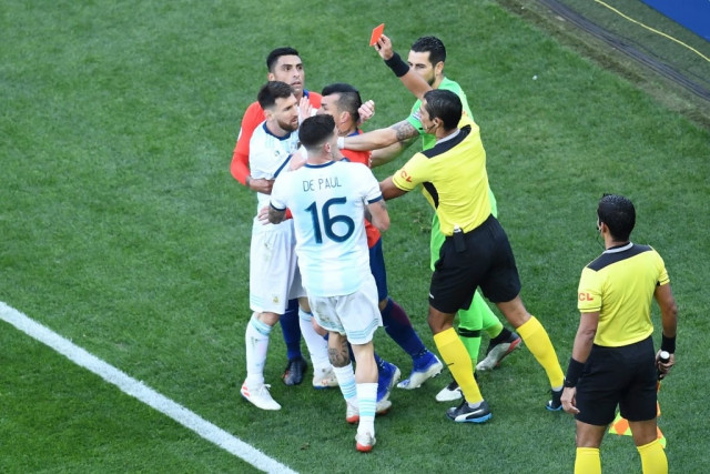 harsh decision messi was involved in a tangle with chile captain medel during the third place match and both players were given their marching orders by referee mario diaz de vivar photo afp harsh decision messi was involved in a tangle with chile captain medel during the third place match and both players were given their marching orders by referee mario diaz de vivar photo afp