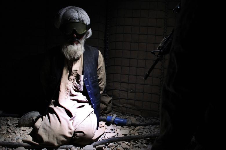 An Afghan man is detained by US Marines from the First Battalion, Eighth Marines Bravo Company at their base in Talibjan after a battle against Taliban insurgents in Musa Qala district in southern Afghanistan's Helmand province November 7, 2010. [Photo: Reuters]