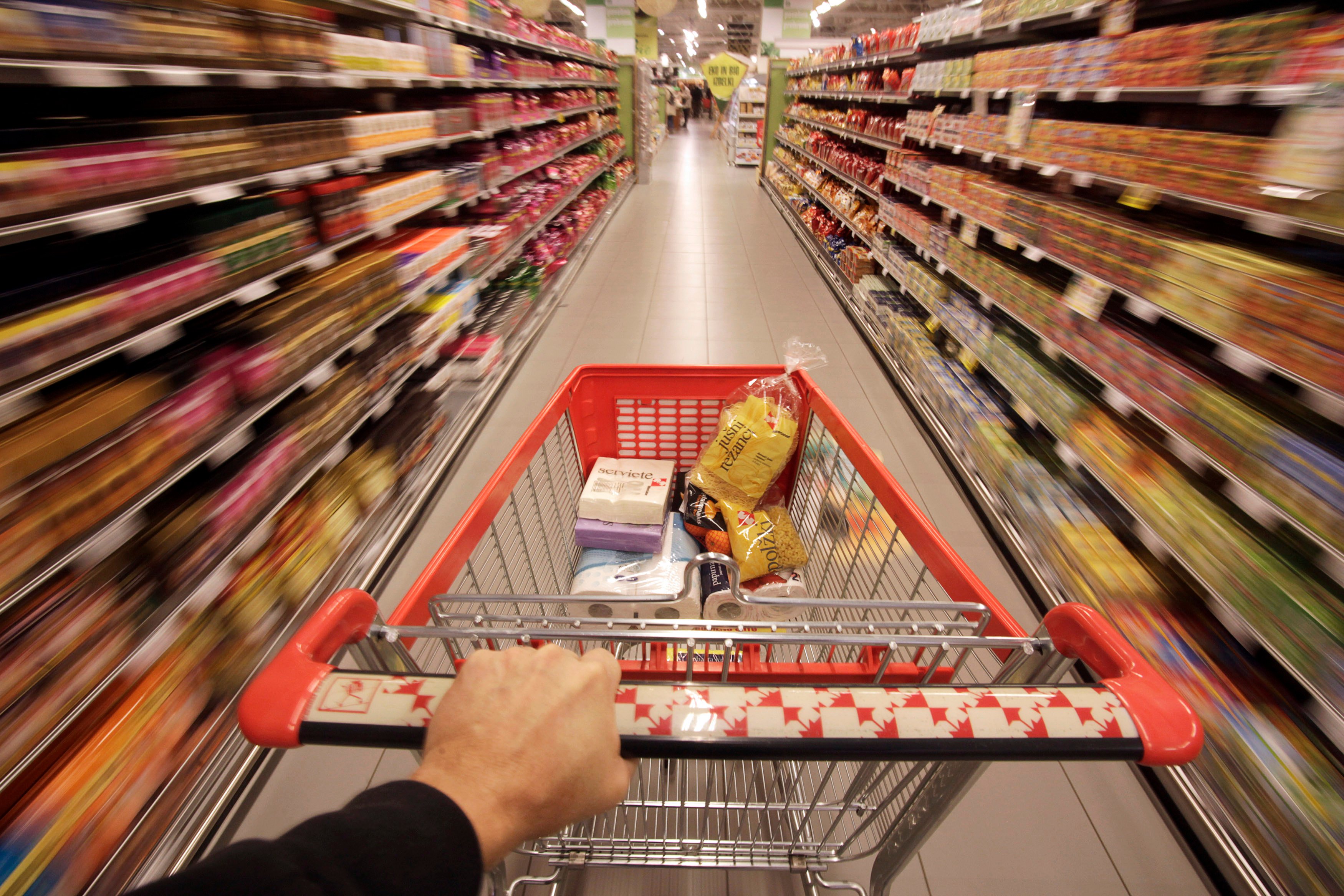 a shopping cart is pushed down the aisle in this reuters photo illustration