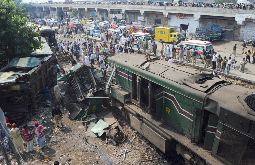 pakistani security officials and local residents gather beside a train wreckage following a crash in lahore on august 30 2011 at least two people were killed and 17 others wounded five of them critically when two trains collided in the eastern pakistani city of lahore train travel is popular among pakistan 039 s poorer classes but the railways have been hit by a severe funding shortfall and a lack of barriers at most level crossings are a frequent cause of small accidents photo afp