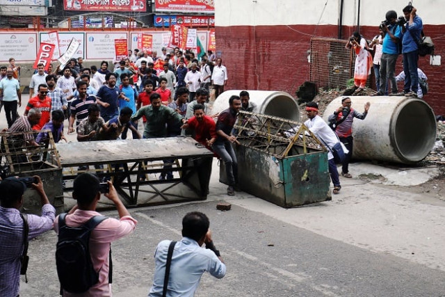 people cross a barricade near the ministry of power energy and mineral resources as they protest against hike in natural gas price photo reuters people cross a barricade near the ministry of power energy and mineral resources as they protest against hike in natural gas price photo reuters