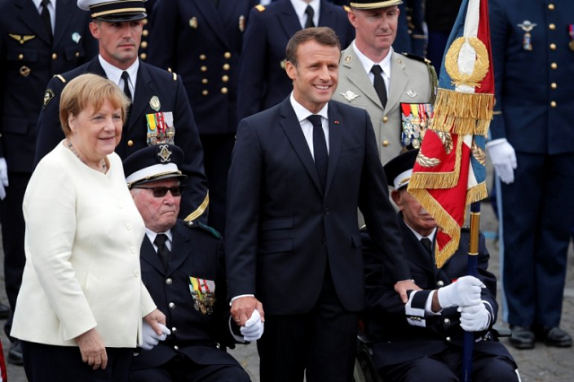 german chancellor angela merkel and french president emmanuel macron attend the traditional bastille day military parade on the champs elysees avenue in paris france july 14 2019 photo reuters german chancellor angela merkel and french president emmanuel macron attend the traditional bastille day military parade on the champs elysees avenue in paris france july 14 2019 photo reuters