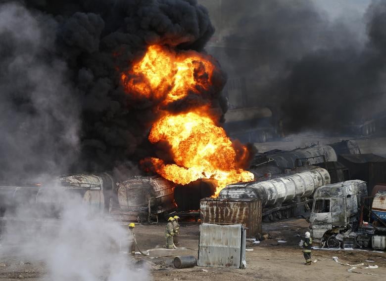 Smoke and flames rise from fuel trucks after an overnight attack by the Taliban on the outskirts of Kabul, July 5, 2014. [Photo: Reuters]