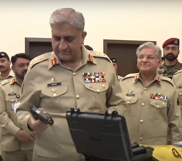 coas gen qamar inspects a locally manufactured gun during a two day national seminar titled defence production   security through self reliance held at army auditorium in rawalpindi screengrab